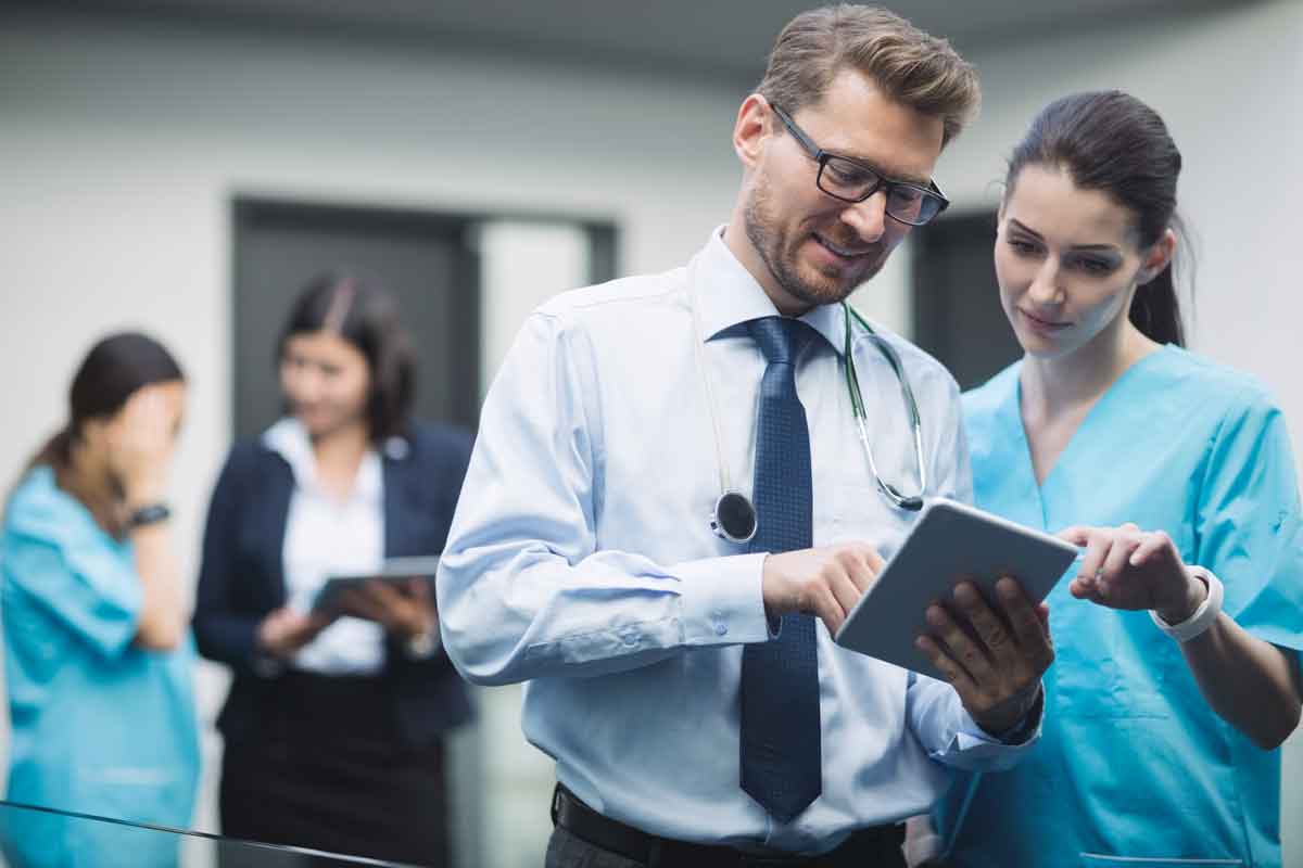 doctor nurse discussing digital tablet